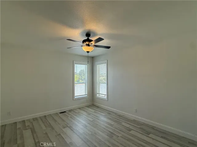 a view of an empty room and wooden floor