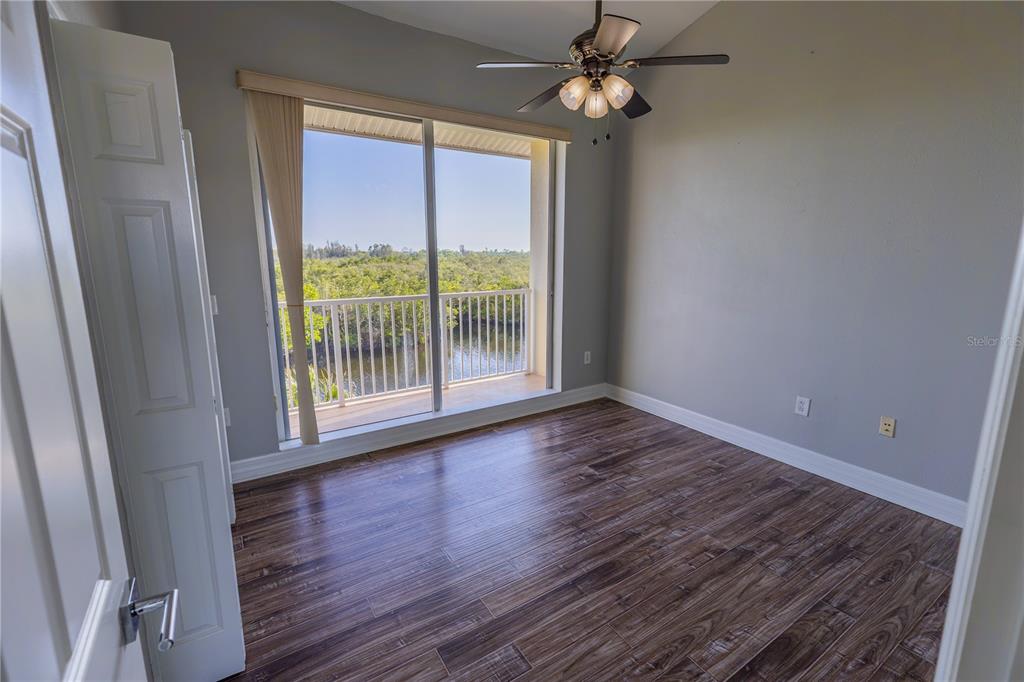 3210 Mangrove Point Drive Ruskin, FL 33570 - Photo 21 of 48 a view of empty room with wooden floor and fan