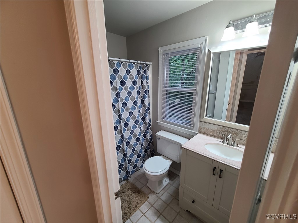 5800 Mill Spring Lane Midlothian, VA 23112 - Photo 17 of 29 a bathroom with a sink toilet and shower