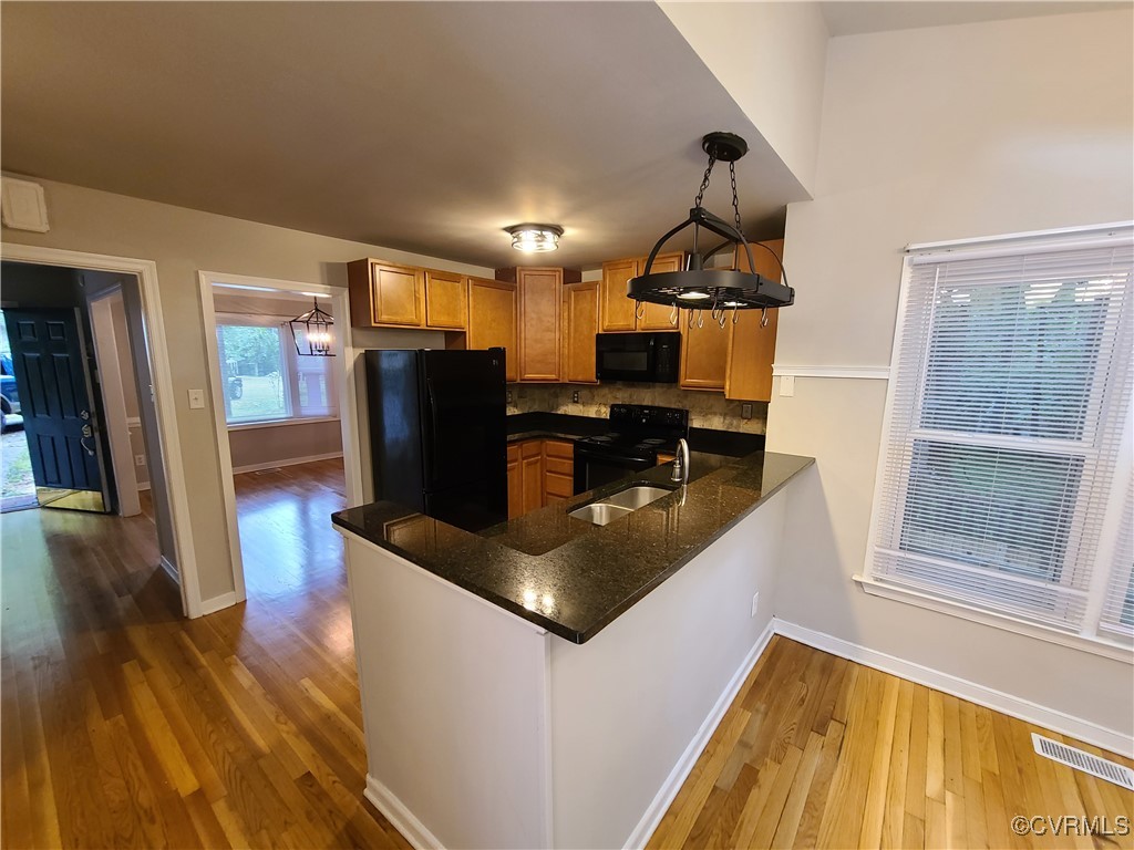 5800 Mill Spring Lane Midlothian, VA 23112 - Photo 2 of 29 a kitchen with stainless steel appliances granite countertop a sink dishwasher a refrigerator and wooden floor