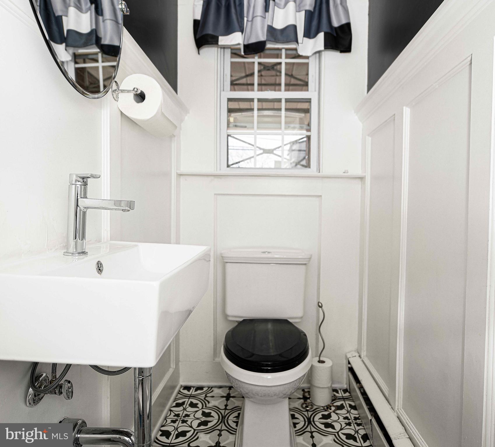 6701 Loch Raven Boulevard Baltimore, MD 21286 - Photo 18 of 44 a bathroom with a sink and a toilet