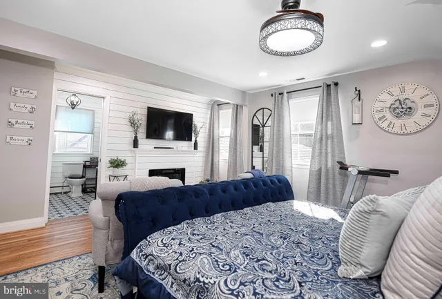 a bedroom with a large bed and a flat screen tv