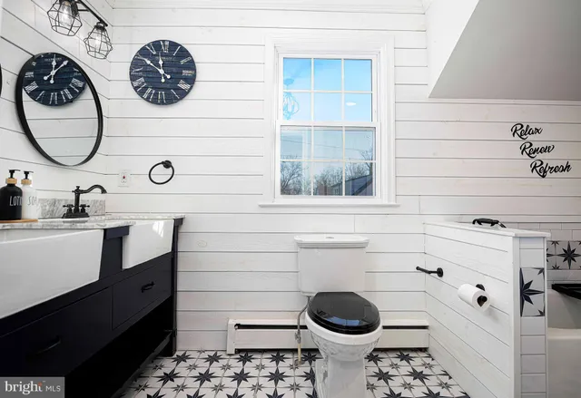 a bathroom with a toilet and a sink