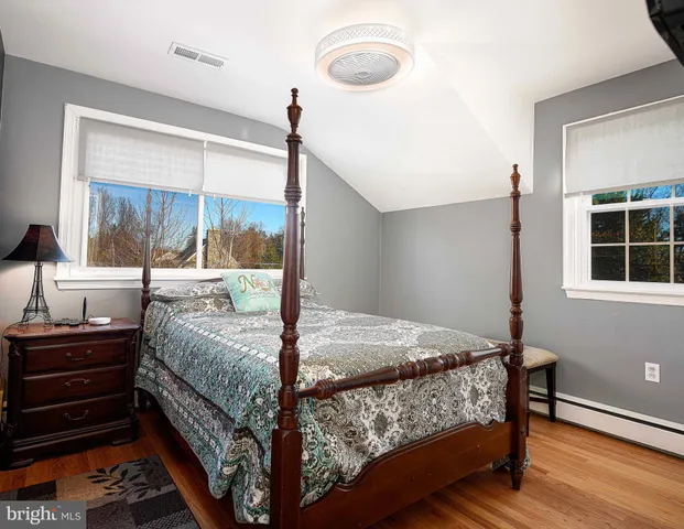 a bedroom with a bed and large window