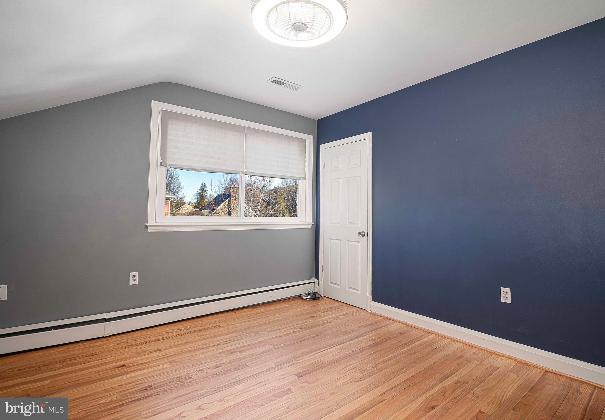 6701 Loch Raven Boulevard Baltimore, MD 21286 - Photo 28 of 44 a view of empty room with wooden floor and fan