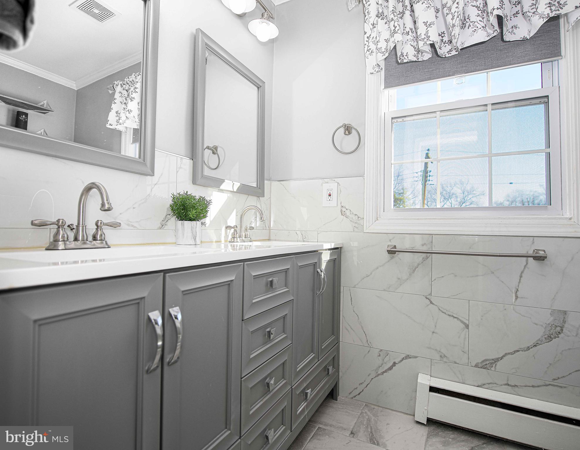 6701 Loch Raven Boulevard Baltimore, MD 21286 - Photo 29 of 44 a bathroom with a sink and a mirror