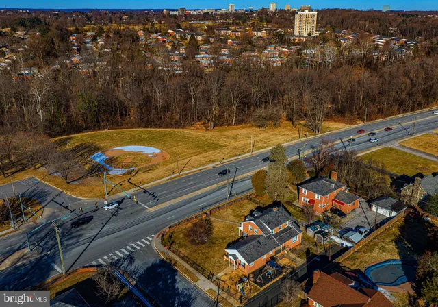 an aerial view of residential houses with yard