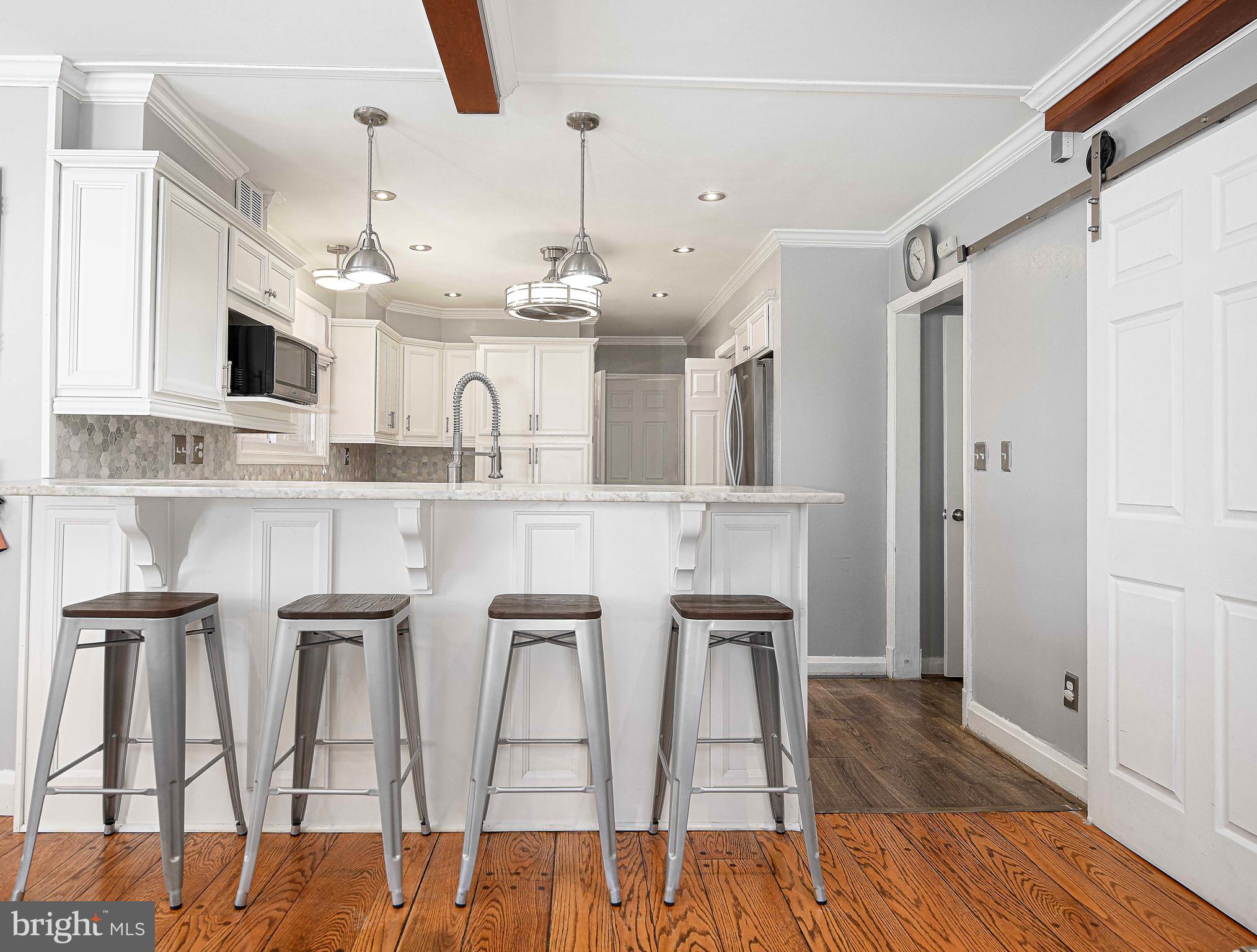 6701 Loch Raven Boulevard Baltimore, MD 21286 - Photo 7 of 44 a kitchen with cabinets and wooden floor