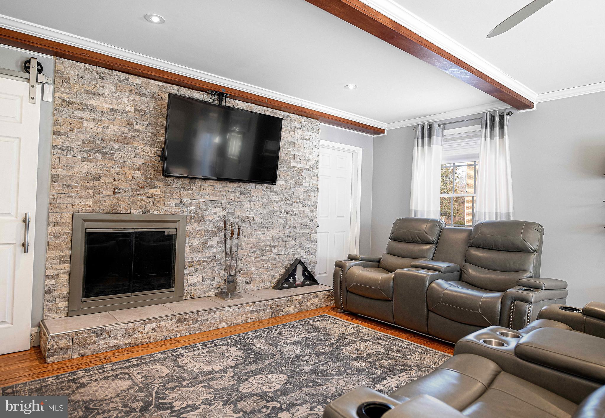 6701 Loch Raven Boulevard Baltimore, MD 21286 - Photo 10 of 44 a living room with furniture a flat screen tv and a fireplace