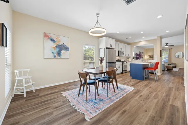 a view of a dining room with furniture wooden floor and chandelier