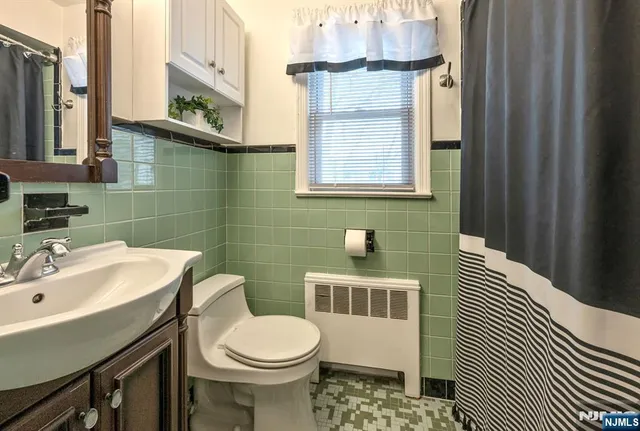 a bathroom with a sink a toilet and mirror