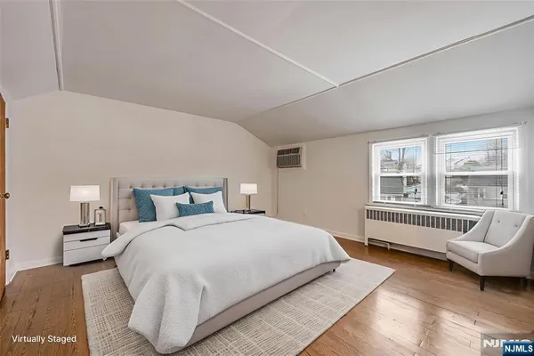 a bedroom with bed and a large window