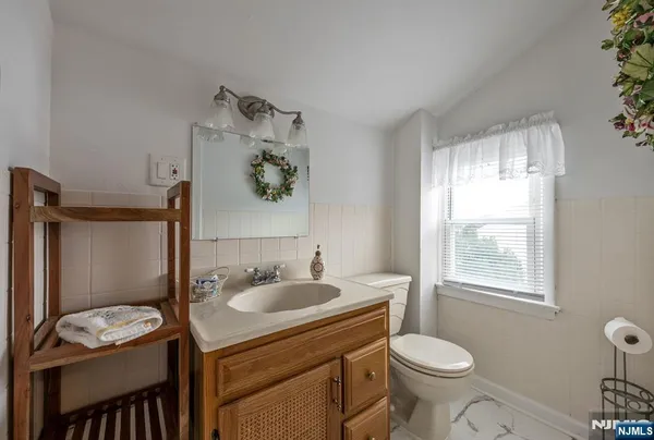 a bathroom with a sink toilet and window