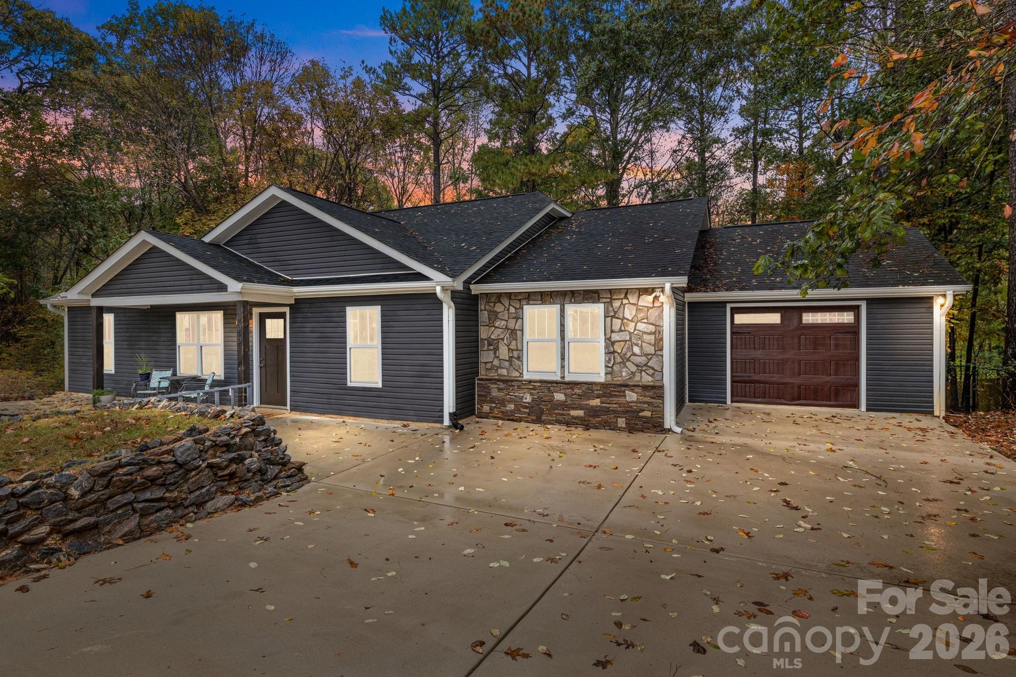 996 Cornelius Road Mooresville, NC 28117 - Photo 1 of 26 a front view of a house with a yard and garage