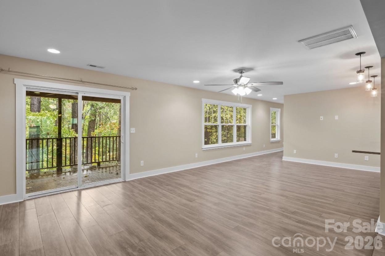 996 Cornelius Road Mooresville, NC 28117 - Photo 11 of 26 a view of an empty room with a window and wooden floor