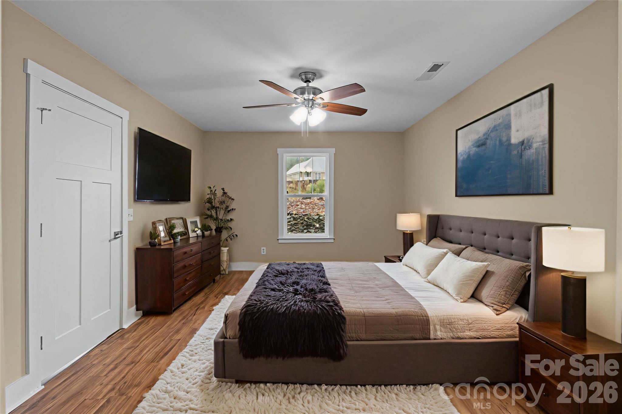 996 Cornelius Road Mooresville, NC 28117 - Photo 12 of 26 a bedroom with a bed and a flat screen tv