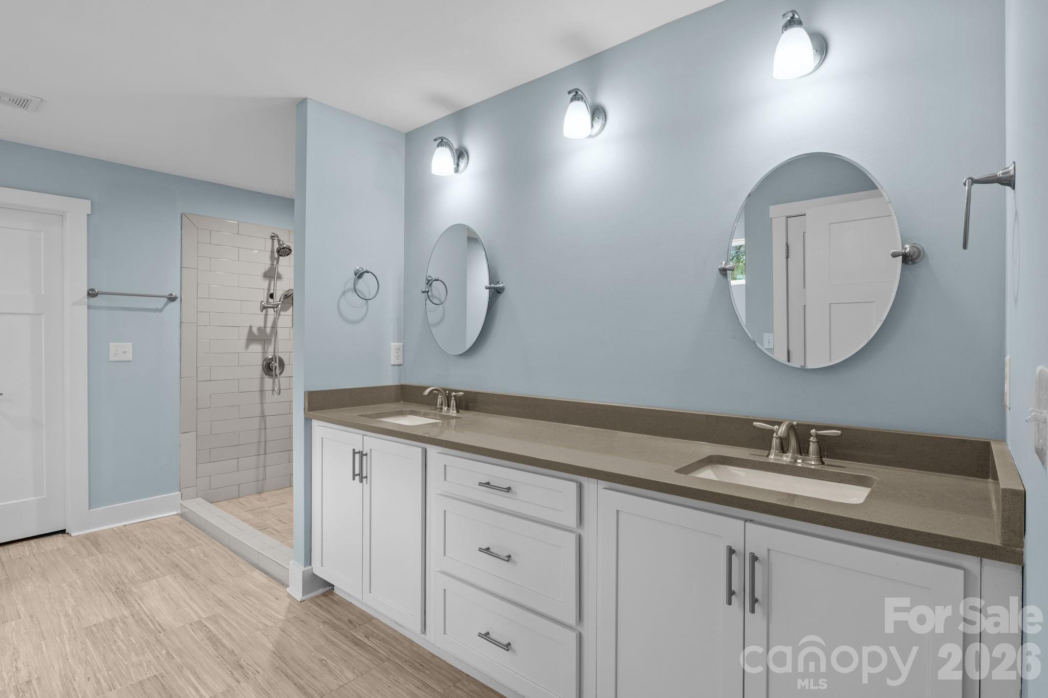996 Cornelius Road Mooresville, NC 28117 - Photo 15 of 26 a bathroom with a granite countertop double vanity sink and a mirror