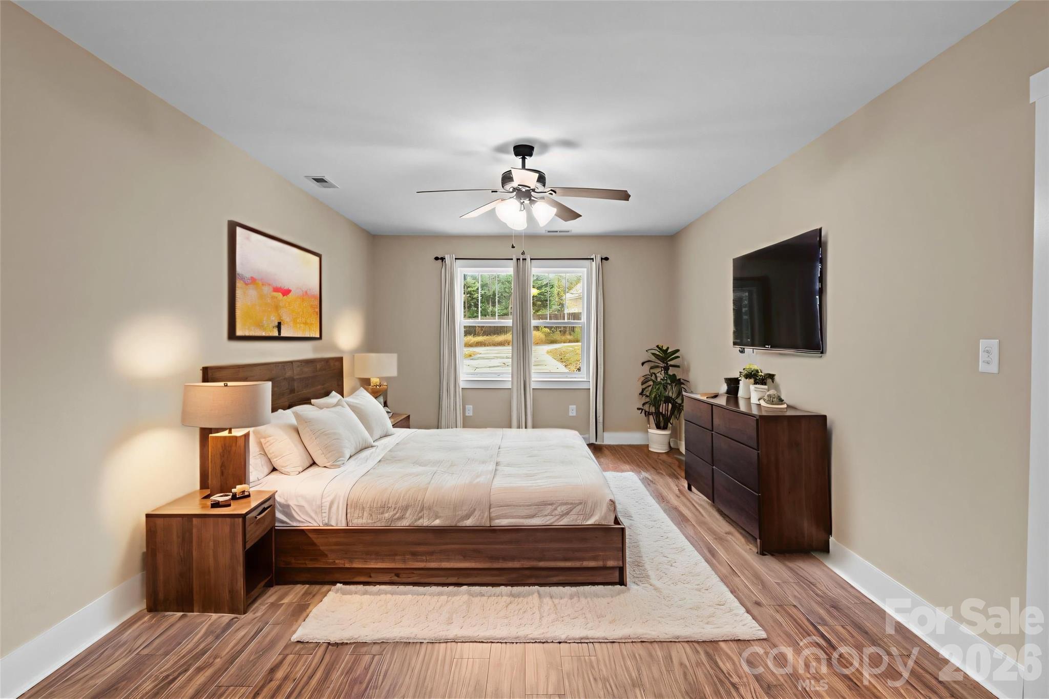 996 Cornelius Road Mooresville, NC 28117 - Photo 16 of 26 a bedroom with a bed and a flat screen tv