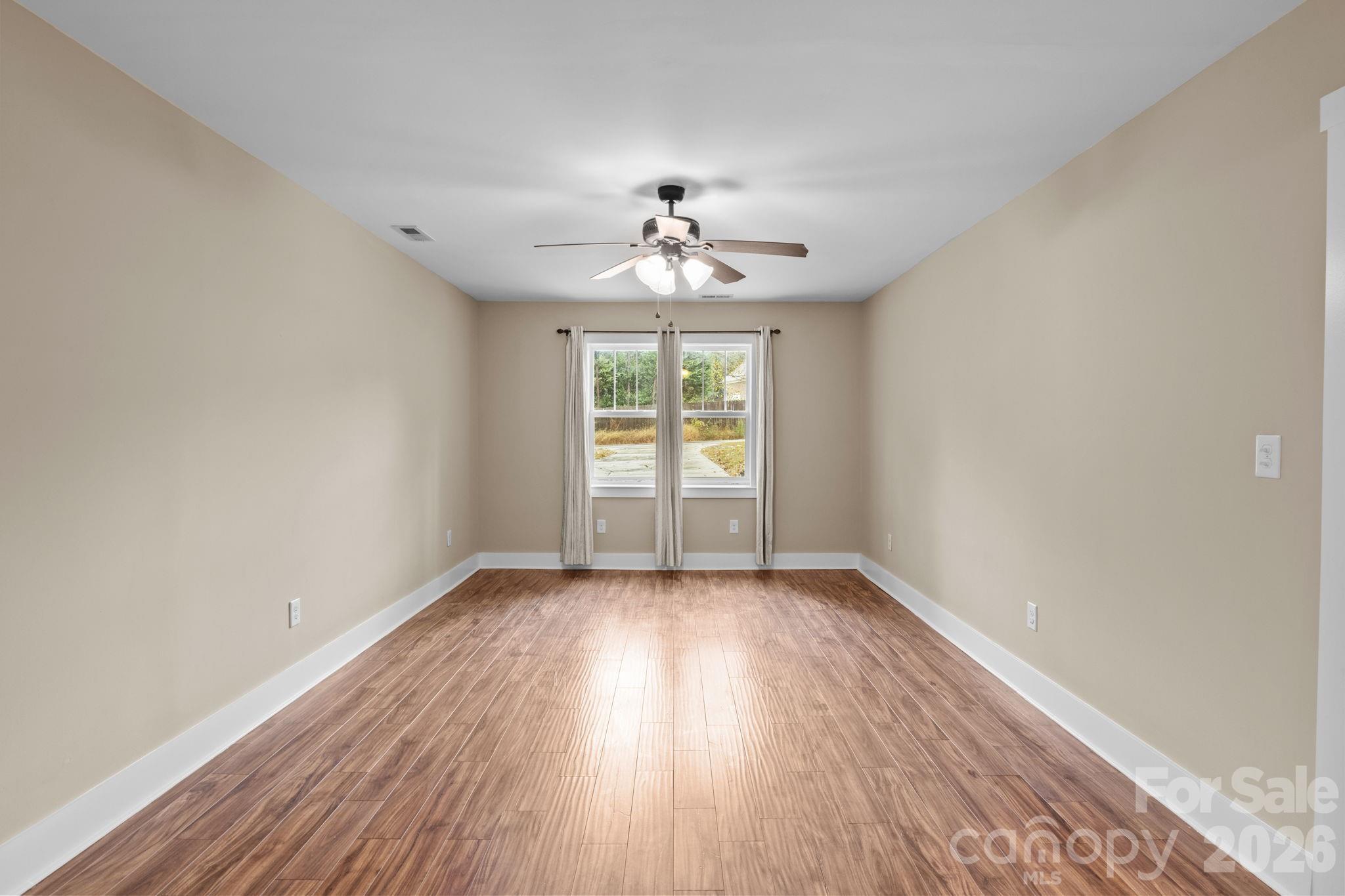 996 Cornelius Road Mooresville, NC 28117 - Photo 17 of 26 wooden floor in an empty room with a window