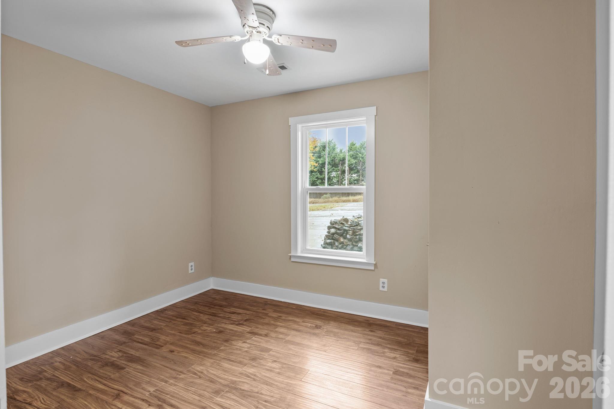 996 Cornelius Road Mooresville, NC 28117 - Photo 21 of 26 an empty room with wooden floor and windows