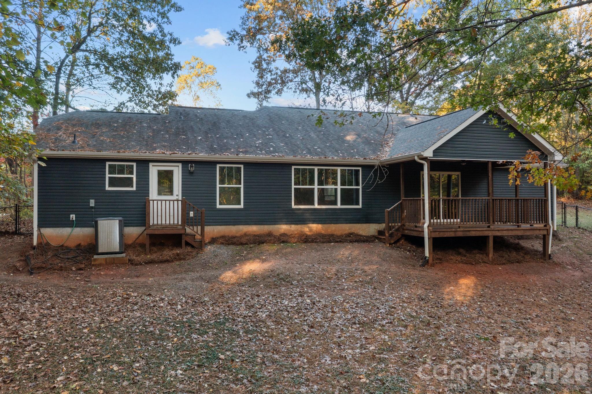 996 Cornelius Road Mooresville, NC 28117 - Photo 24 of 26 a view of a house with a yard and large tree