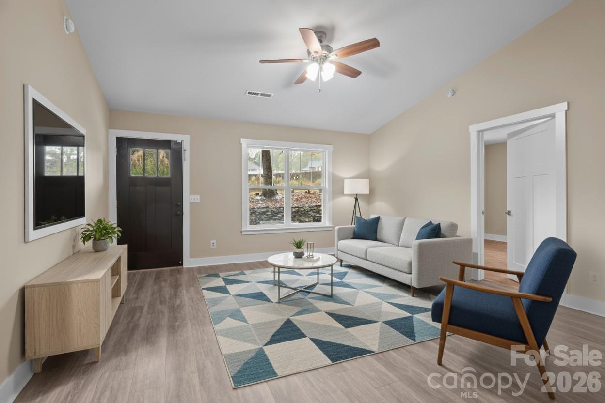 996 Cornelius Road Mooresville, NC 28117 - Photo 5 of 26 a living room with furniture and a flat screen tv