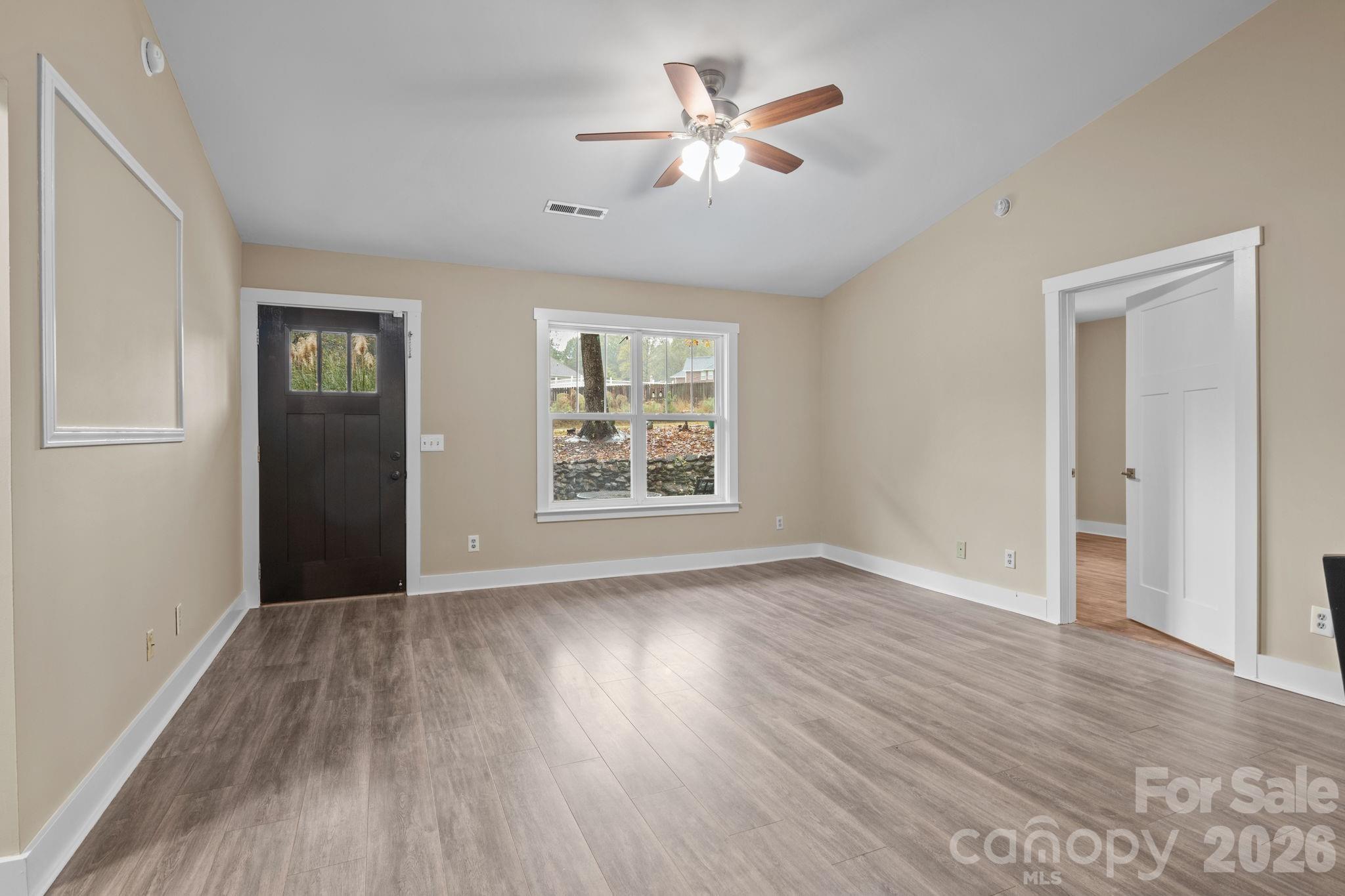 996 Cornelius Road Mooresville, NC 28117 - Photo 6 of 26 a view of an empty room with a window and wooden floor