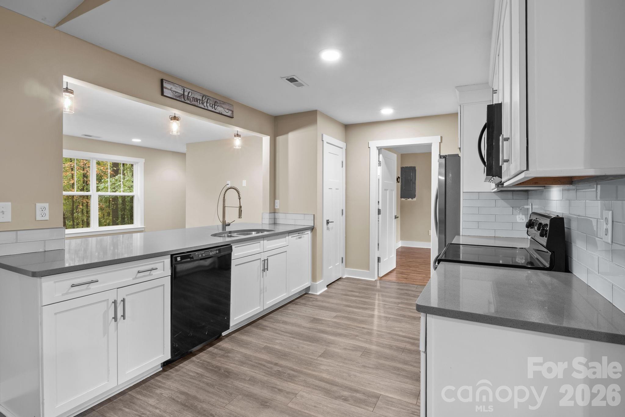 996 Cornelius Road Mooresville, NC 28117 - Photo 7 of 26 a large kitchen with stainless steel appliances granite countertop a lot of counter space and wooden floor