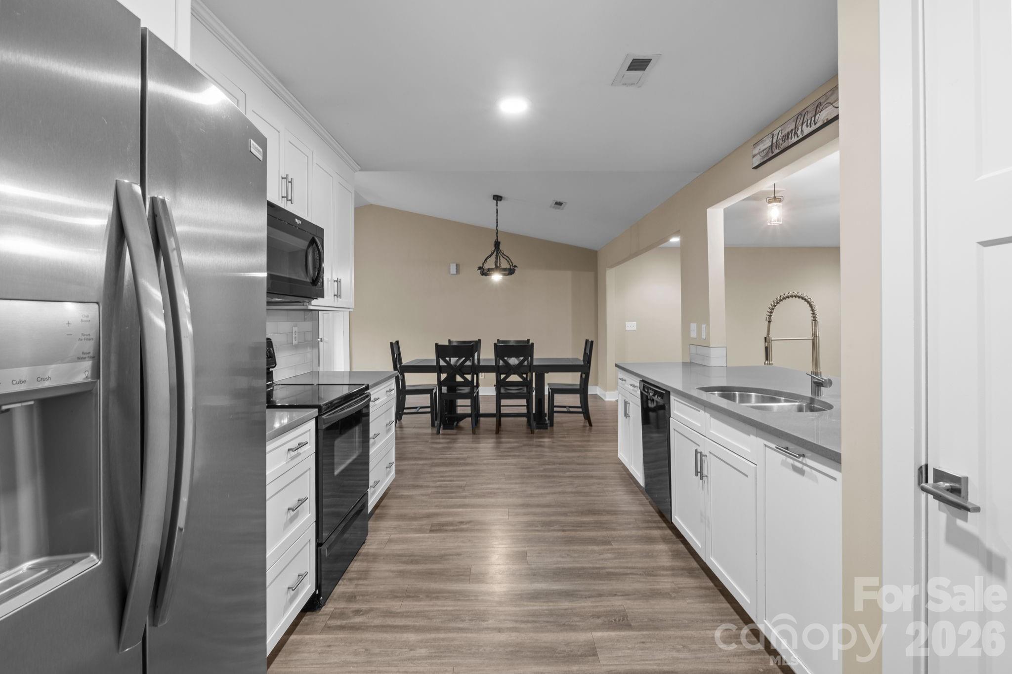 996 Cornelius Road Mooresville, NC 28117 - Photo 9 of 26 a kitchen with stainless steel appliances granite countertop a stove top oven a sink and a refrigerator