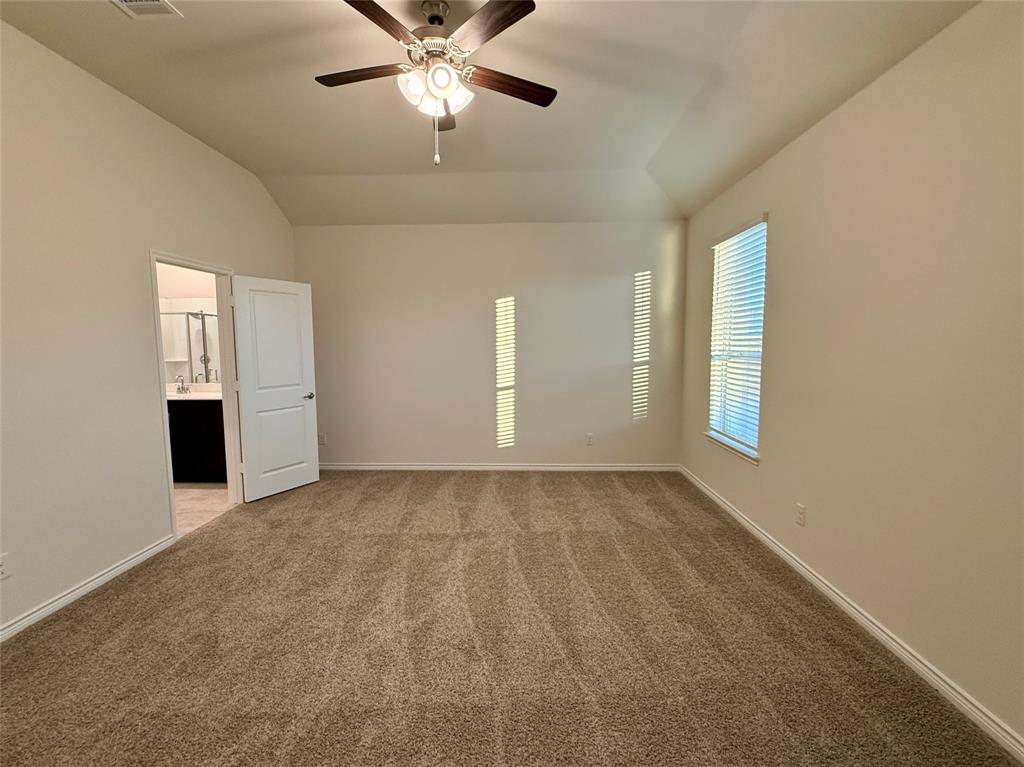 2025 Eugene Street Anna, TX 75409 - Photo 12 of 32 an empty room with chandelier fan and windows