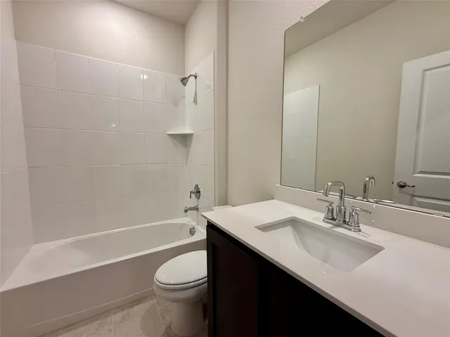 an empty room with a window and a ceiling fan