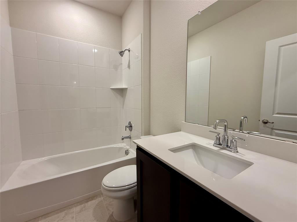 2025 Eugene Street Anna, TX 75409 - Photo 18 of 32 a bathroom with a sink a toilet and shower