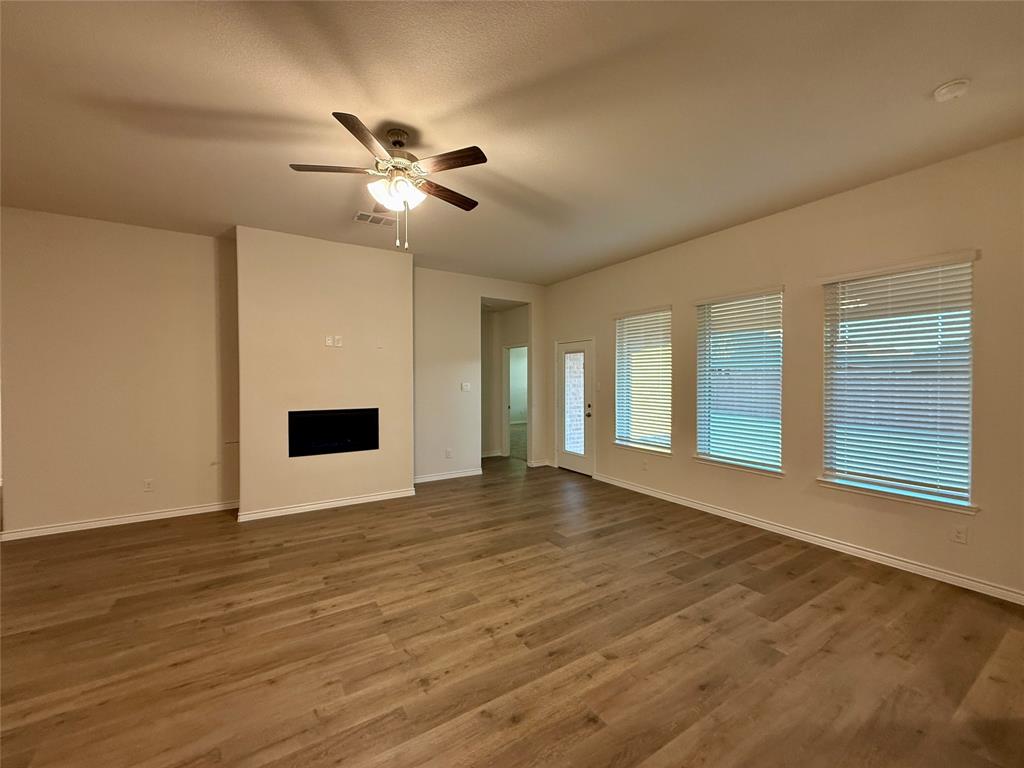 2025 Eugene Street Anna, TX 75409 - Photo 3 of 32 a view of an empty room with window and wooden floor