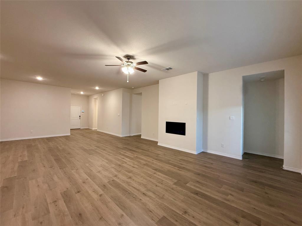 2025 Eugene Street Anna, TX 75409 - Photo 7 of 32 a view of an empty room with wooden floor