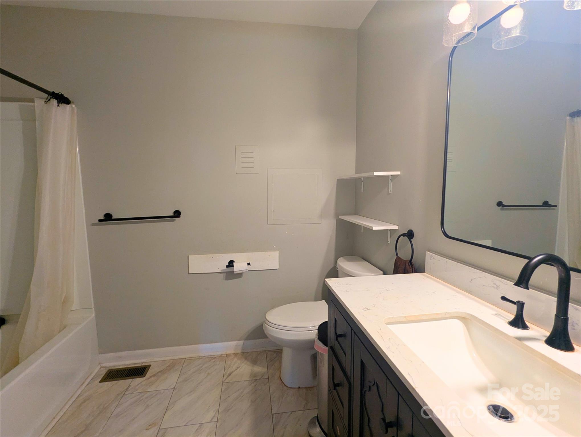 1737 Whiteside Road Forest City, NC 28043 - Photo 12 of 18 a bathroom with a sink a toilet and shower