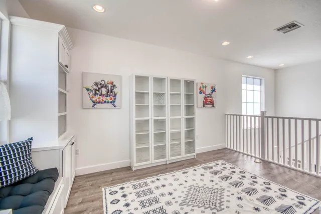 a bedroom with a bed a chair and a chandelier