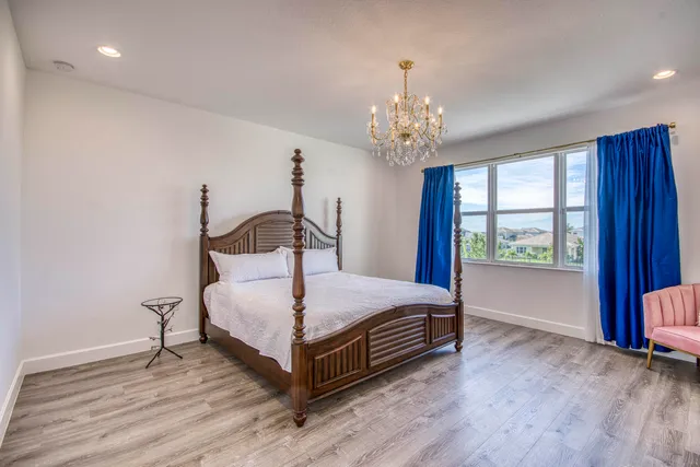 a bedroom with a bed and a chandelier