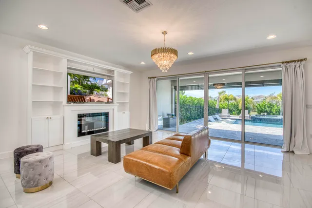 a living room with furniture and kitchen view