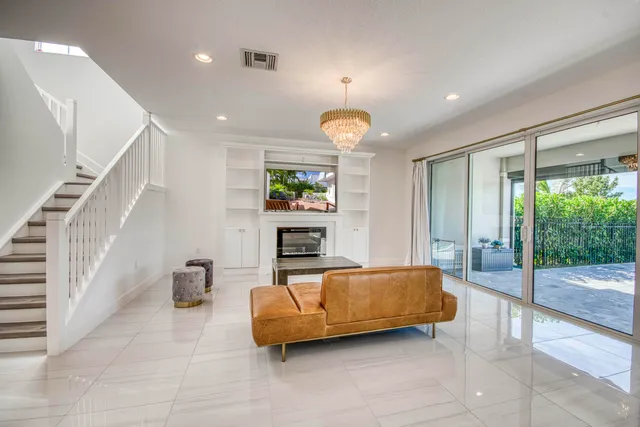 a kitchen with a refrigerator a stove top oven a sink dishwasher a dining table and chairs with wooden floor