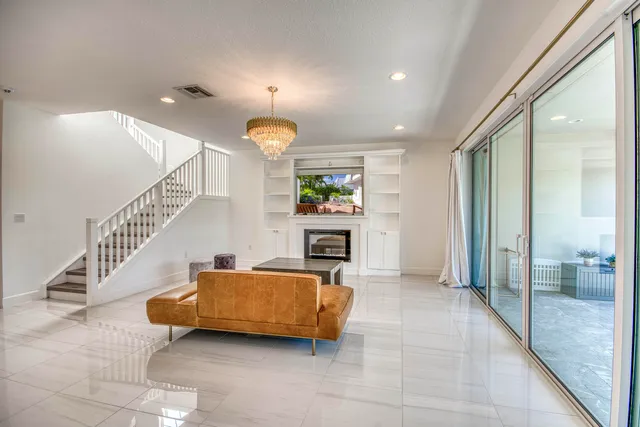 a kitchen with stainless steel appliances granite countertop dining table chairs and white cabinets