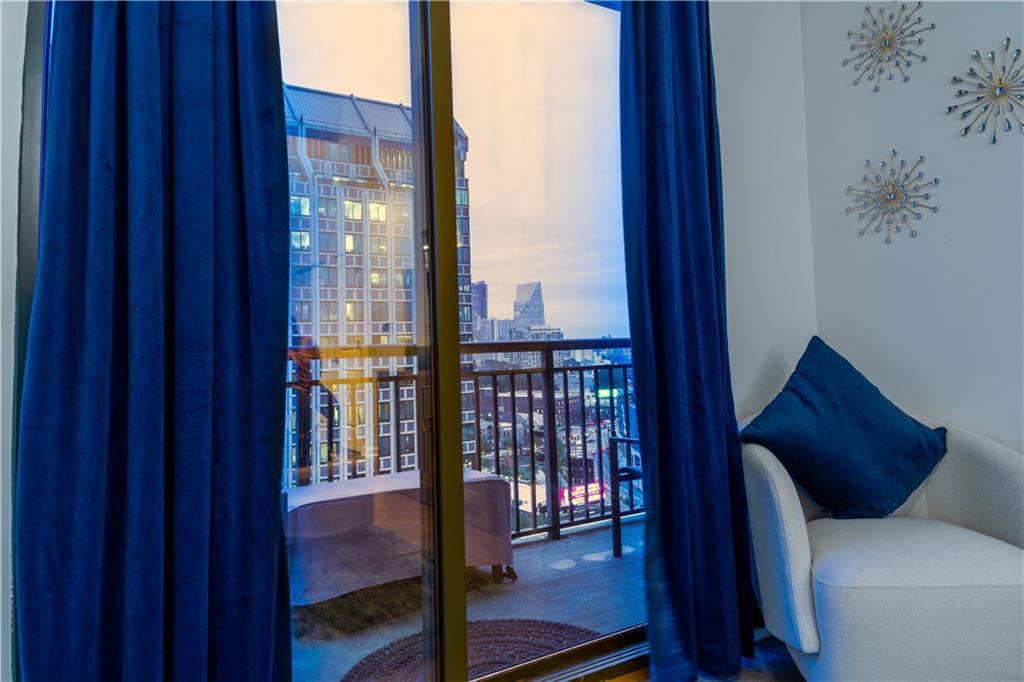 3040 Peachtree Road Northwest, Unit 1602 Atlanta, GA 30305 - Photo 5 of 12 a living room with furniture and a window