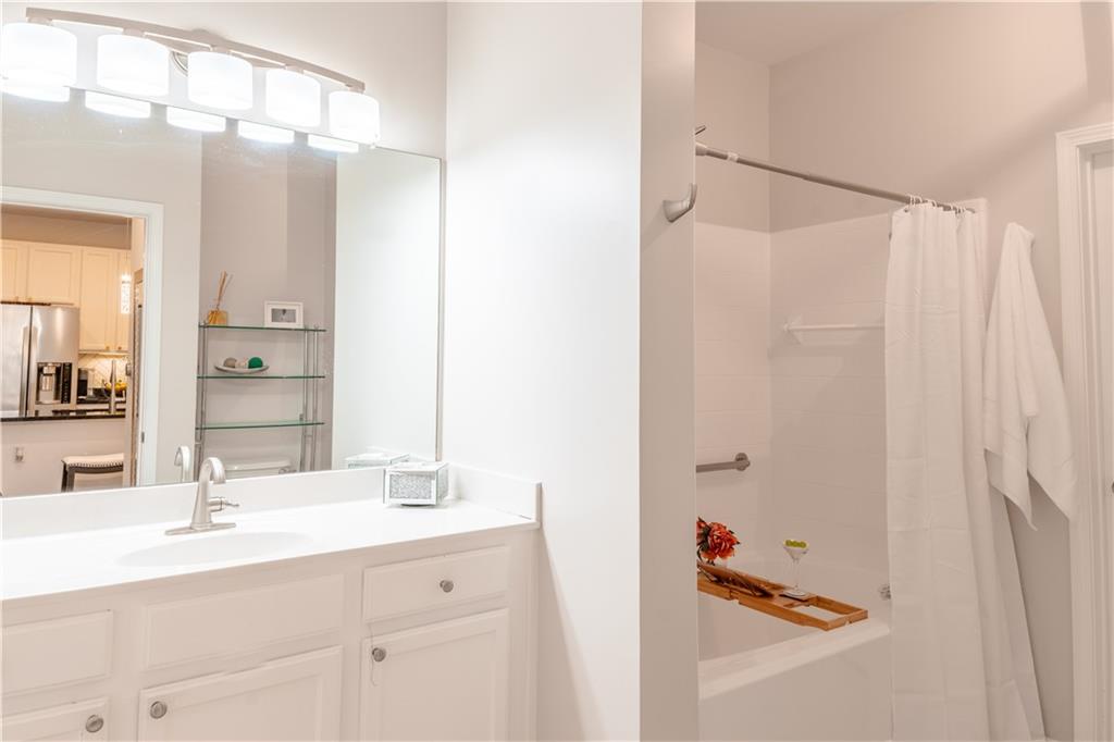3040 Peachtree Road Northwest, Unit 1602 Atlanta, GA 30305 - Photo 6 of 12 a bathroom with a double vanity sink and mirror