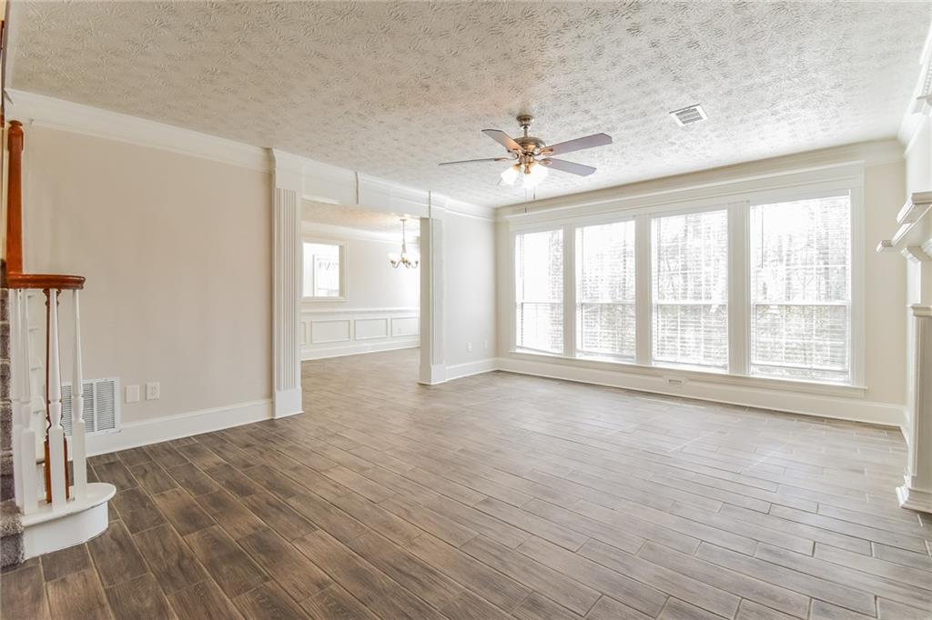3543 Benthollow Way Duluth, GA 30096 - Photo 13 of 25 a view of an empty room with a window and wooden floor