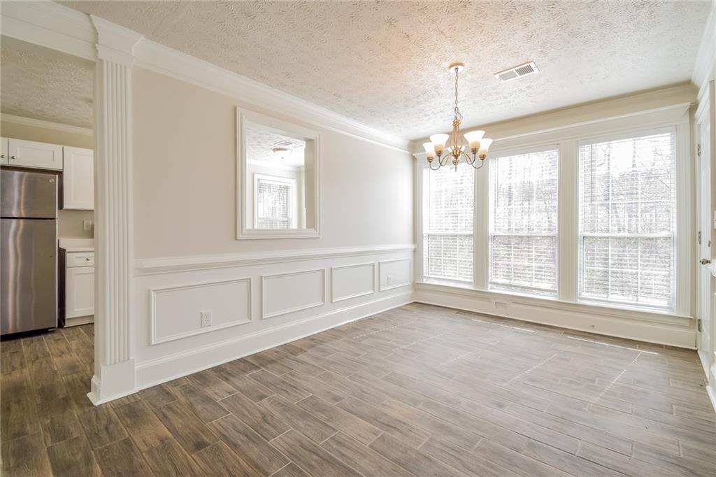 3543 Benthollow Way Duluth, GA 30096 - Photo 15 of 25 a view of an empty room with a window and wooden floor