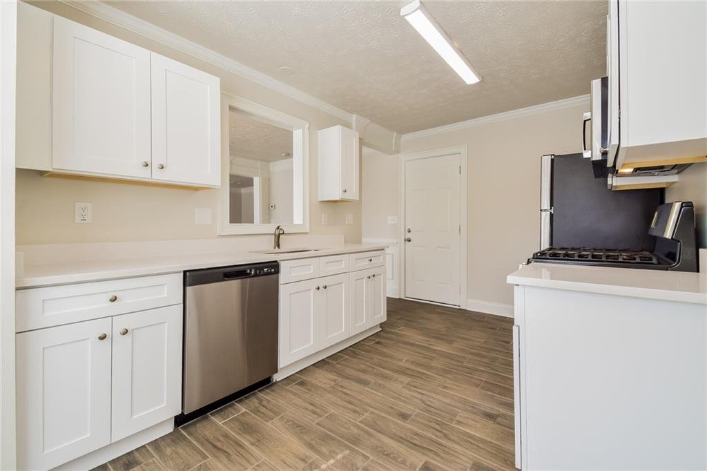 3543 Benthollow Way Duluth, GA 30096 - Photo 16 of 25 a kitchen with a sink cabinets and a window
