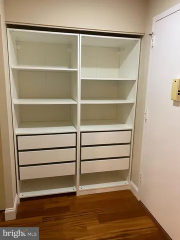 a view of walk in closet with empty racks