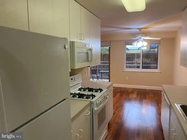 a kitchen with stainless steel appliances a refrigerator and a stove top oven