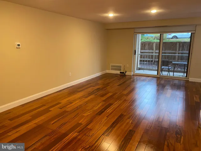 a view of room with wooden floor and fan