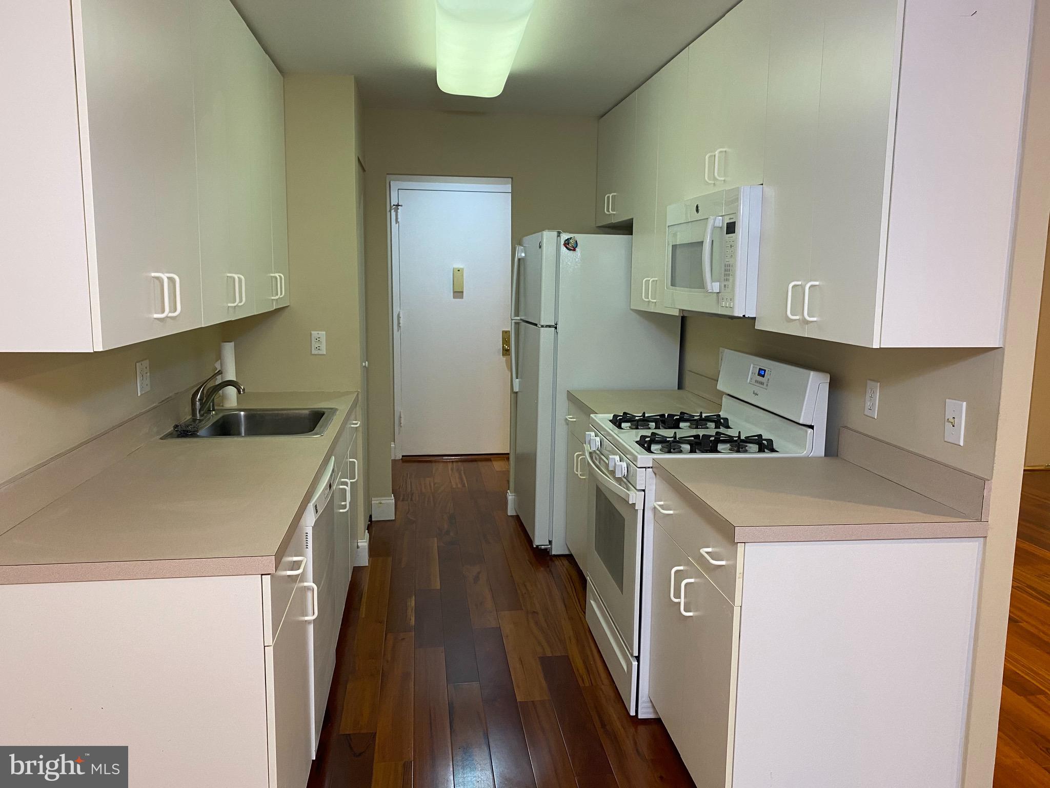 1637 Oakwood Drive, Unit S103 Narberth, PA 19072 - Photo 3 of 23 a kitchen with a stove and a refrigerator