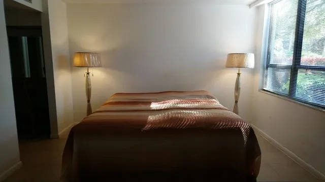 a bedroom with a bed and window